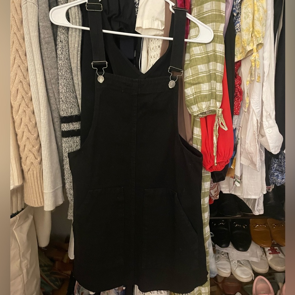 Black overall dress. Raw hem, buttons down the side